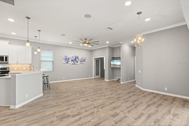 2808 124th Ave E, Parrish, FL 34219 - living area featuring recessed lighting, light wood-type flooring, ceiling fan, crown molding, and a chandelier