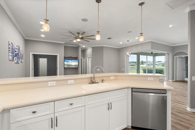 2808 124th Ave E, Parrish, FL 34219 - kitchen with stainless steel dishwasher, light wood finished floors, white cabinets, ornamental molding, and pendant lighting
