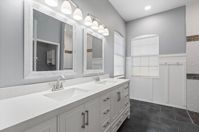 2808 124th Ave E, Parrish, FL 34219 - full bathroom featuring double vanity, a wainscoted wall, and tile patterned floors