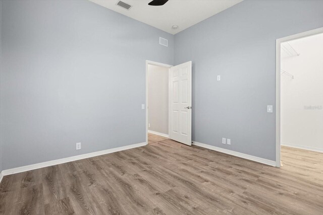 2808 124th Ave E, Parrish, FL 34219 - empty room with wood finished floors, a ceiling fan, and high vaulted ceiling