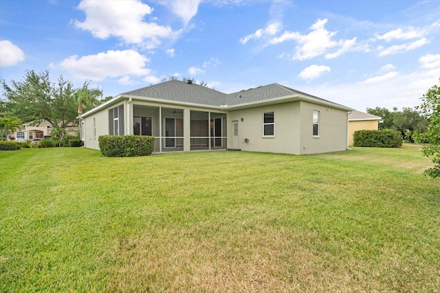 2808 124th Ave E, Parrish, FL 34219 - rear view of house featuring a lawn, a sunroom, stucco siding, and roof with shingles