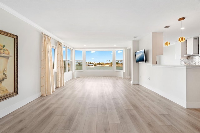 unfurnished living room featuring light wood finished floors and baseboards