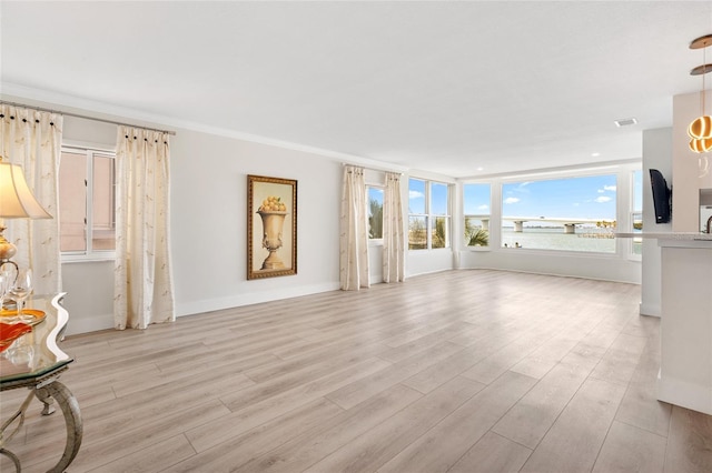 unfurnished living room with light wood-style flooring, baseboards, and crown molding