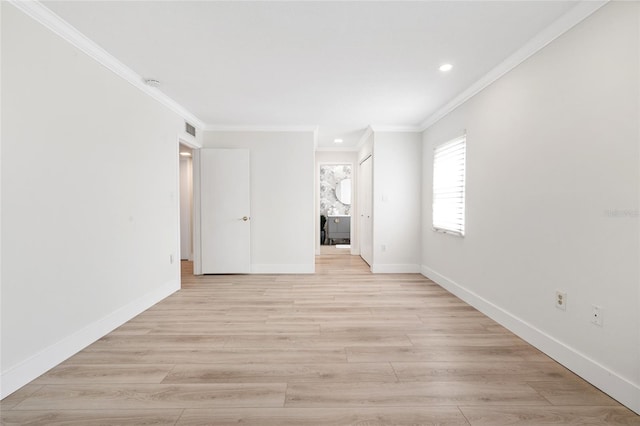 spare room featuring crown molding, recessed lighting, baseboards, and light wood finished floors
