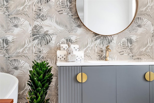 bathroom with vanity and a soaking tub