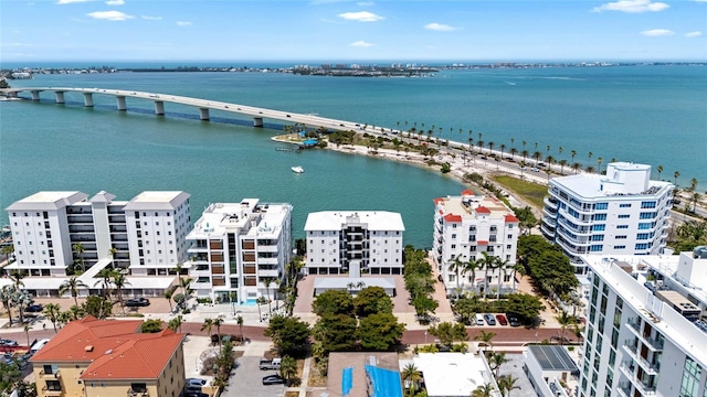 aerial view of a notable bridge, apartment complex / building, and a nearby body of water