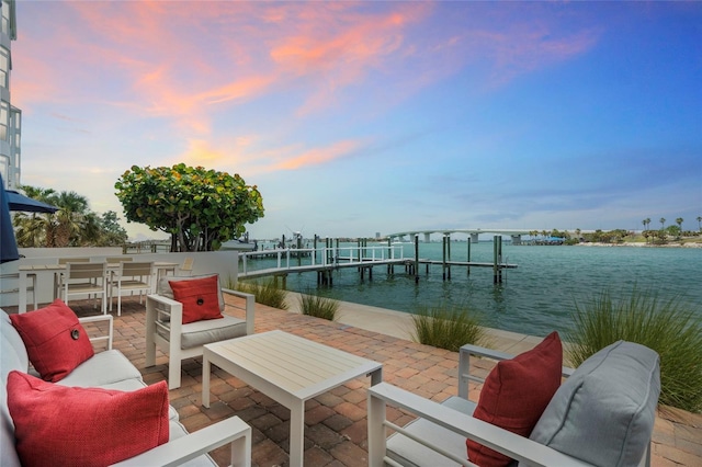 174 Golden Gate Pt Unit 21, Sarasota, FL 34236 - wooden deck featuring a water view, a dock, a patio, and an outdoor hangout area
