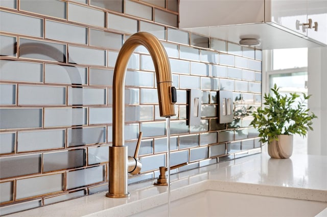 174 Golden Gate Pt Unit 21, Sarasota, FL 34236 - detailed view of backsplash, light stone counters, and a sink