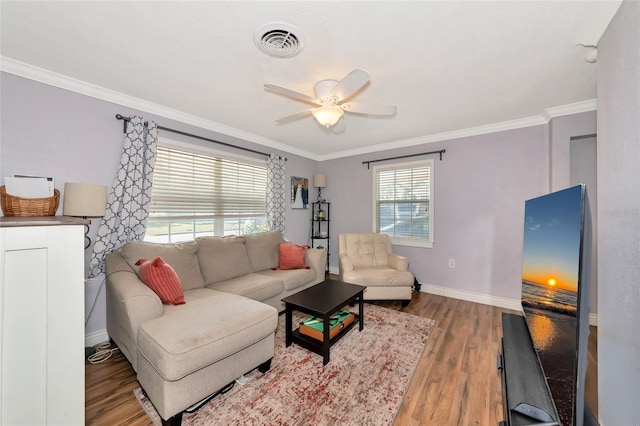 2004 19th St W, Bradenton, FL 34205 - living area with crown molding, wood finished floors, baseboards, and a ceiling fan