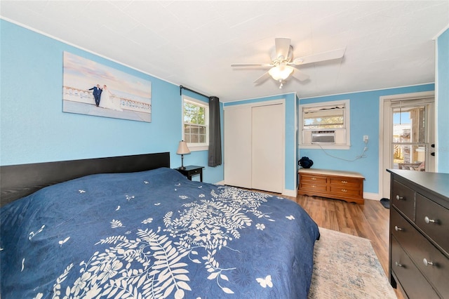 2004 19th St W, Bradenton, FL 34205 - bedroom featuring wood finished floors, a closet, cooling unit, ceiling fan, and baseboards