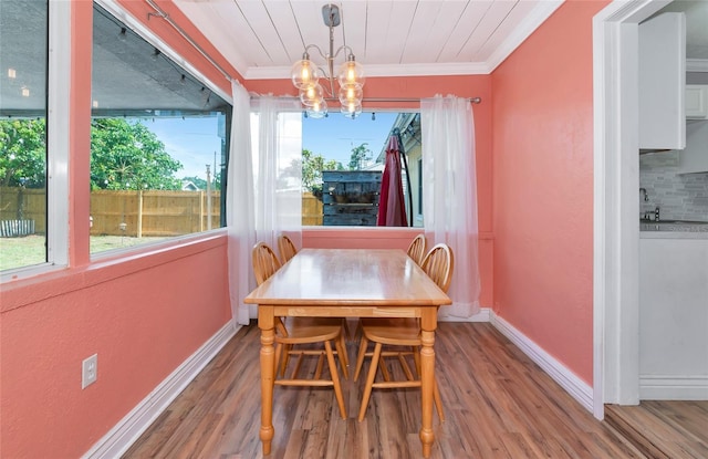 2004 19th St W, Bradenton, FL 34205 - dining space with a chandelier, wood finished floors, ornamental molding, and baseboards