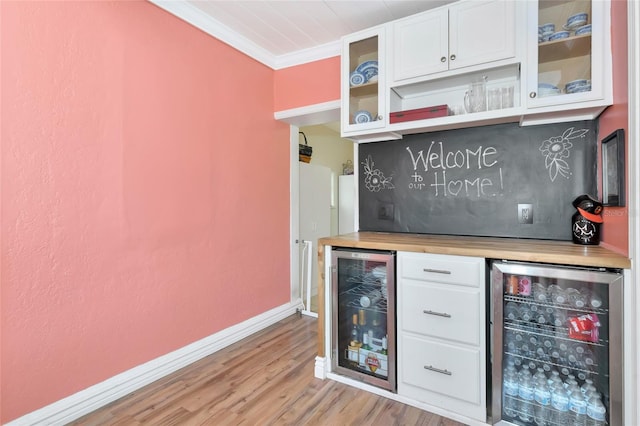 2004 19th St W, Bradenton, FL 34205 - indoor dry bar featuring wine cooler, light wood finished floors, crown molding, and baseboards