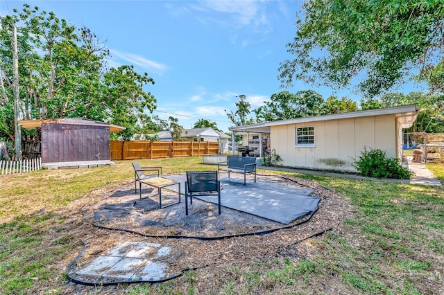 2004 19th St W, Bradenton, FL 34205 - view of yard featuring a storage unit, a patio area, an outbuilding, and an outdoor living space