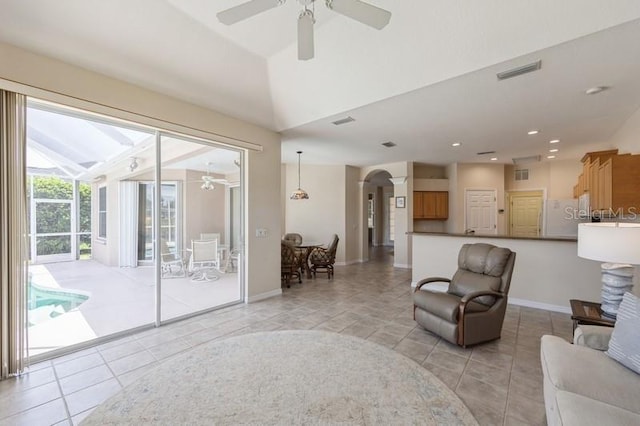 12007 Clubhouse Dr, Lakewood Ranch, FL 34202 - living area featuring ceiling fan, arched walkways, light tile patterned floors, lofted ceiling, and recessed lighting