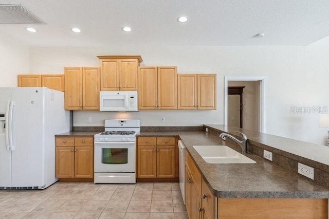12007 Clubhouse Dr, Lakewood Ranch, FL 34202 - kitchen featuring white appliances, a sink, dark countertops, a peninsula, and recessed lighting