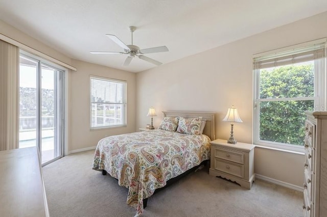 12007 Clubhouse Dr, Lakewood Ranch, FL 34202 - bedroom with light carpet, access to outside, baseboards, and ceiling fan