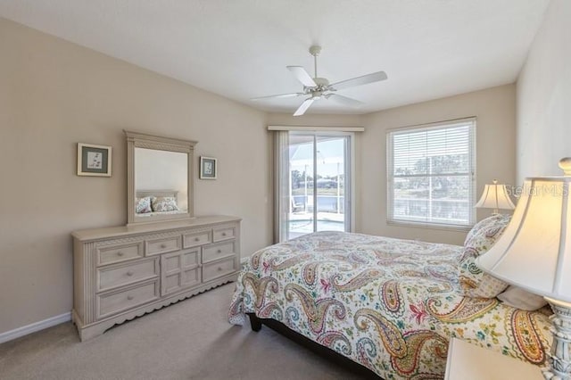 12007 Clubhouse Dr, Lakewood Ranch, FL 34202 - bedroom featuring light colored carpet, access to outside, a ceiling fan, and baseboards