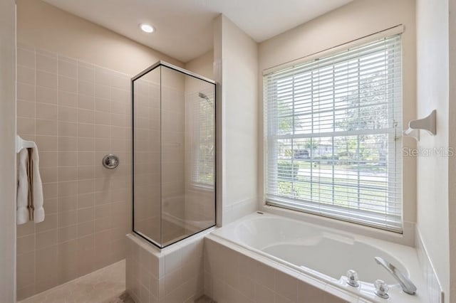 12007 Clubhouse Dr, Lakewood Ranch, FL 34202 - bathroom with tiled shower and a garden tub