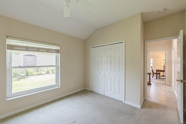 12007 Clubhouse Dr, Lakewood Ranch, FL 34202 - unfurnished bedroom featuring carpet, baseboards, lofted ceiling, and a closet