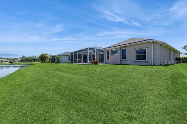 12007 Clubhouse Dr, Lakewood Ranch, FL 34202 - back of house with a lawn, a water view, and stucco siding