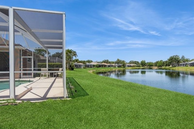 12007 Clubhouse Dr, Lakewood Ranch, FL 34202 - view of grassy yard with a water view, an outdoor pool, glass enclosure, and a patio