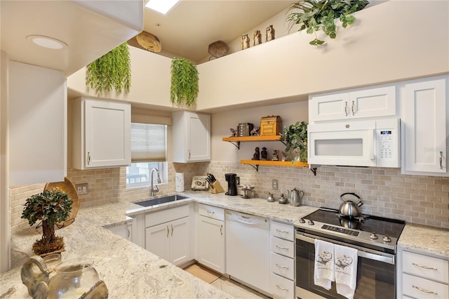 kitchen featuring white appliances, a sink, tasteful backsplash, and white cabinets
