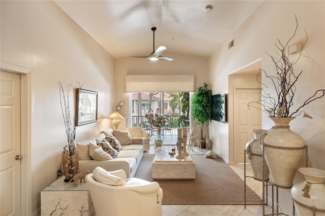 living area featuring lofted ceiling, ceiling fan, and light tile patterned flooring