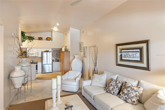 living room with high vaulted ceiling and light tile patterned floors