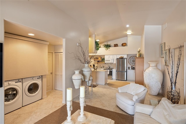 laundry room featuring washer and clothes dryer, light tile patterned floors, and recessed lighting
