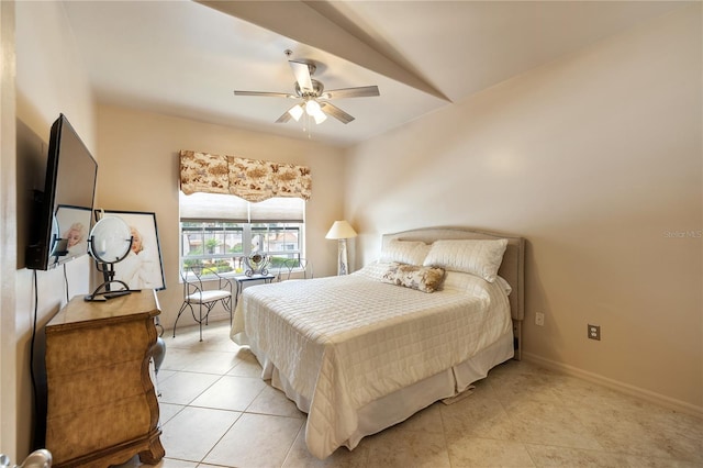 bedroom featuring light tile patterned floors, a ceiling fan, and baseboards