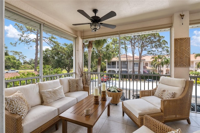 sunroom with ceiling fan and an outdoor living space