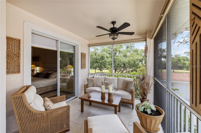 sunroom / solarium featuring a ceiling fan and an outdoor hangout area