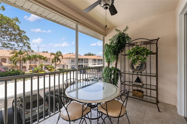 balcony featuring a ceiling fan and a residential view