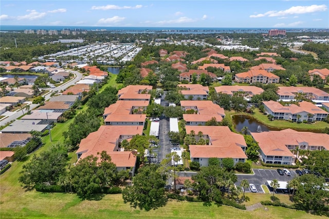 aerial perspective of suburban area with a nearby body of water