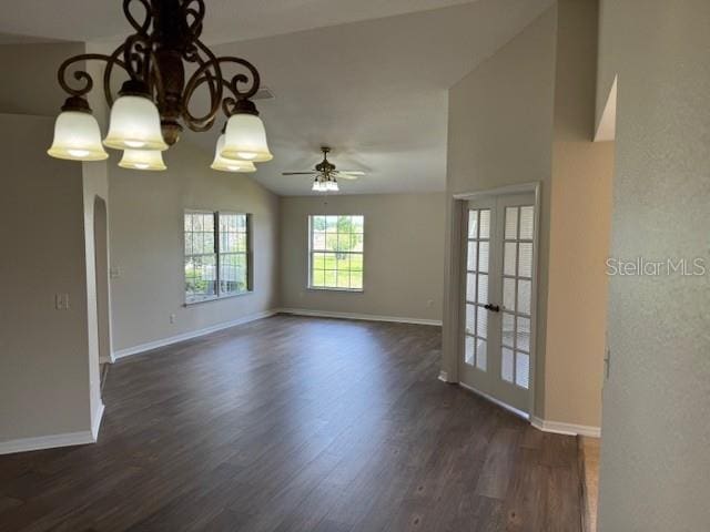 empty room featuring dark wood-type flooring, a ceiling fan, baseboards, french doors, and lofted ceiling