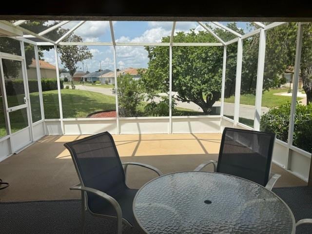 sunroom featuring outdoor dining space