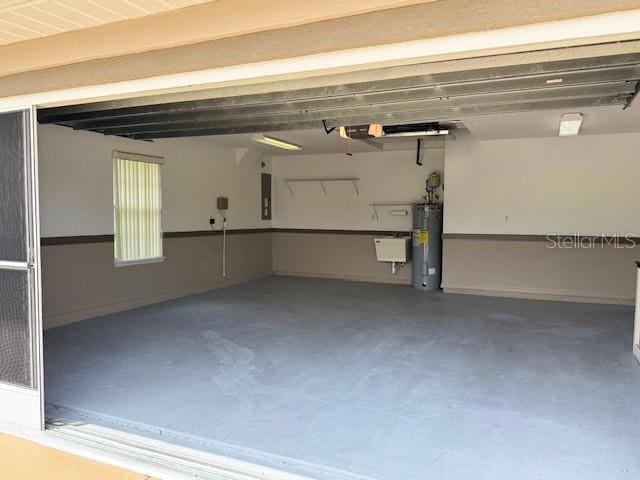 garage with electric water heater and electric panel