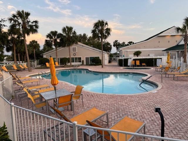 community pool featuring a patio area and fence