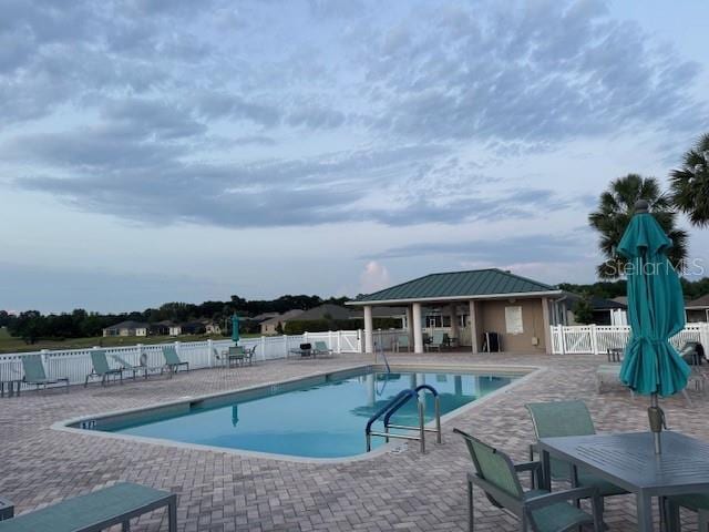 community pool featuring a patio and fence