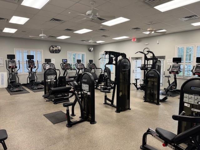 gym featuring ceiling fan and a drop ceiling