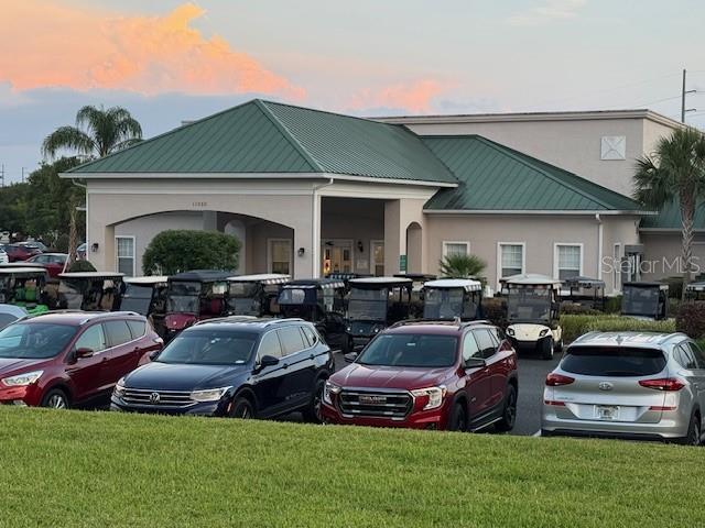 parking at dusk with a lawn and uncovered parking