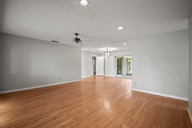 6512 Bowline Dr, Sarasota, FL 34231 - spare room featuring baseboards, recessed lighting, light wood-style floors, ceiling fan, and a chandelier