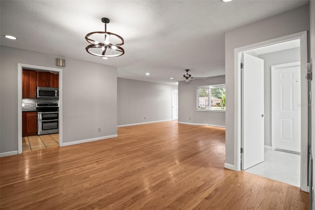 6512 Bowline Dr, Sarasota, FL 34231 - spare room featuring a chandelier, light wood finished floors, recessed lighting, baseboards, and ceiling fan