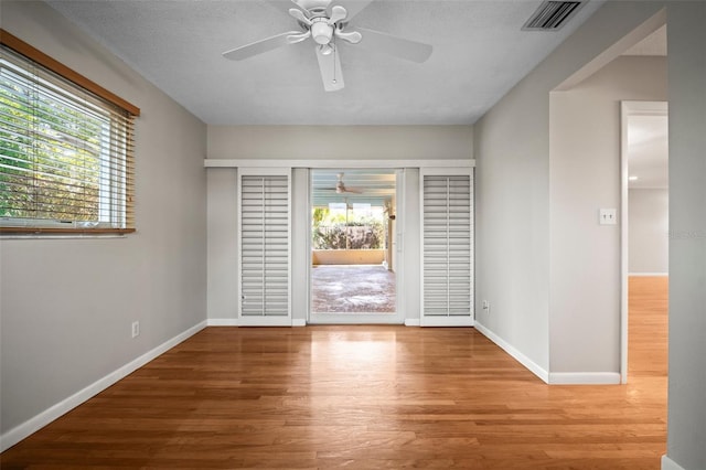 6512 Bowline Dr, Sarasota, FL 34231 - empty room with a ceiling fan, wood finished floors, and baseboards