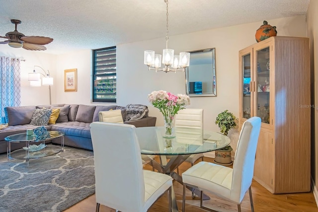 523 Spring Lakes Blvd, Bradenton, FL 34210 - dining area with a chandelier, a textured ceiling, wood finished floors, and a ceiling fan