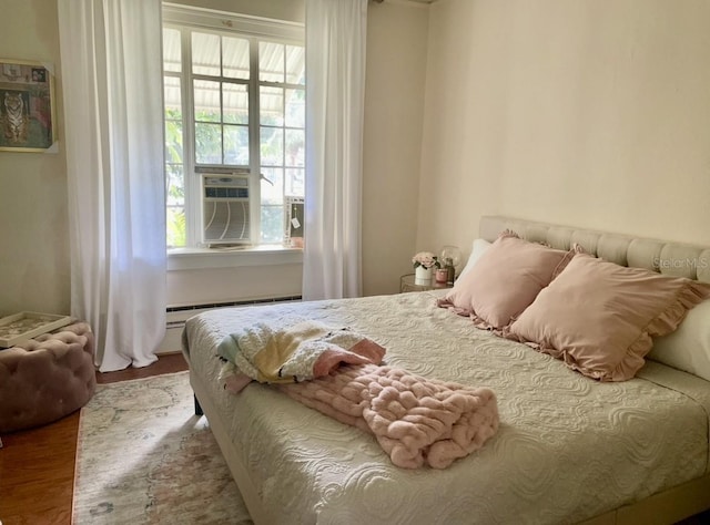 210 N 17th St W Unit 15, Bradenton, FL 34205 - bedroom featuring wood finished floors and baseboard heating