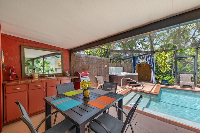 941 Virginia Dr, Sarasota, FL 34234 - view of patio featuring a hot tub, an outdoor kitchen, an outdoor pool, glass enclosure, and a sink