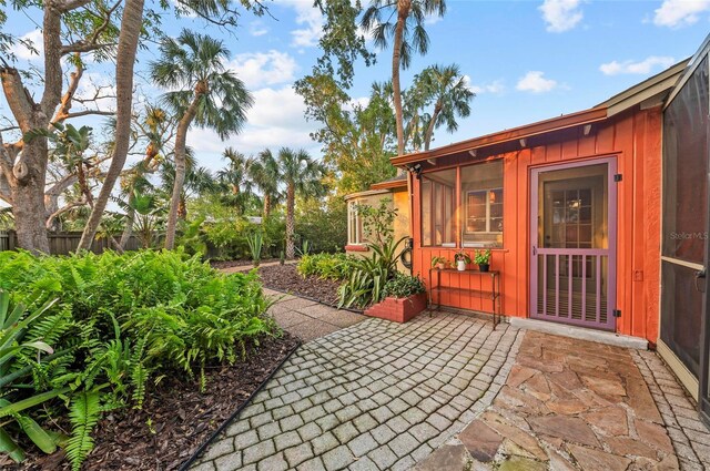 941 Virginia Dr, Sarasota, FL 34234 - property entrance featuring fence, a patio area, and board and batten siding