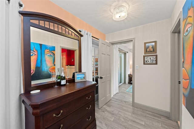 941 Virginia Dr, Sarasota, FL 34234 - corridor featuring light wood finished floors, baseboards, and french doors