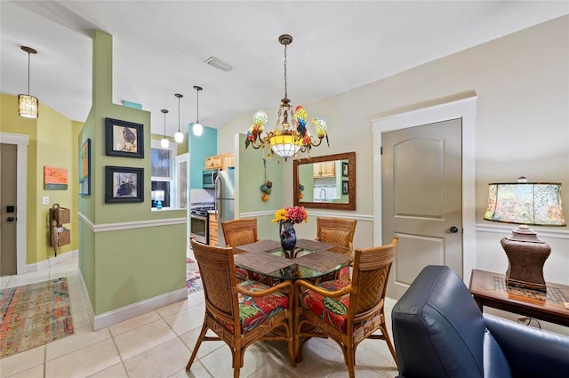 941 Virginia Dr, Sarasota, FL 34234 - dining space with light tile patterned floors, a chandelier, lofted ceiling, and baseboards